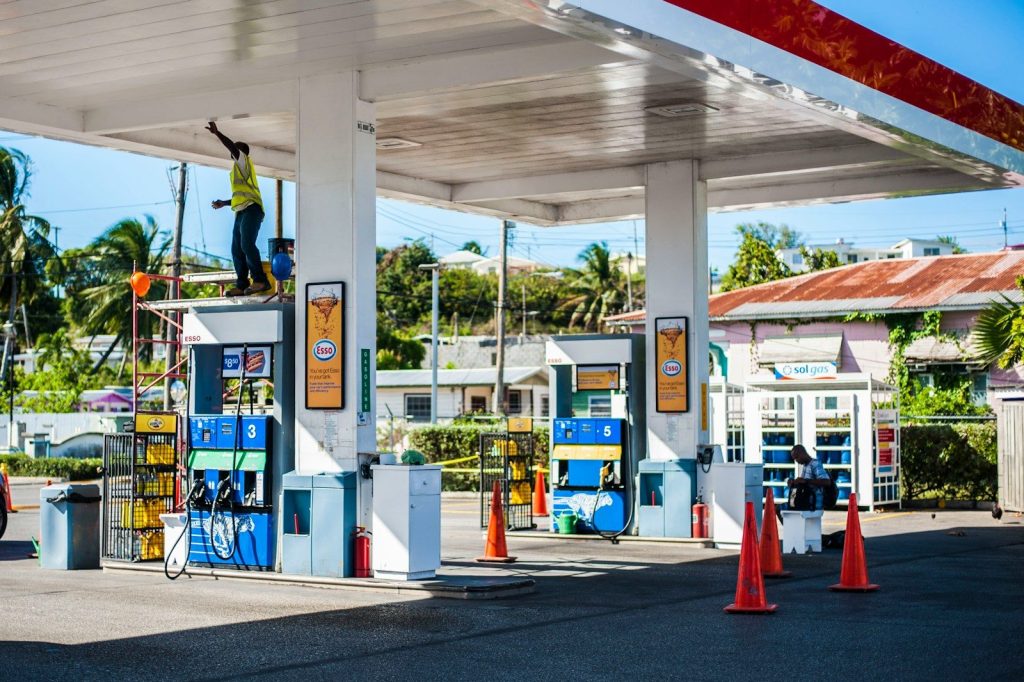 a gas station with a man on a ladder