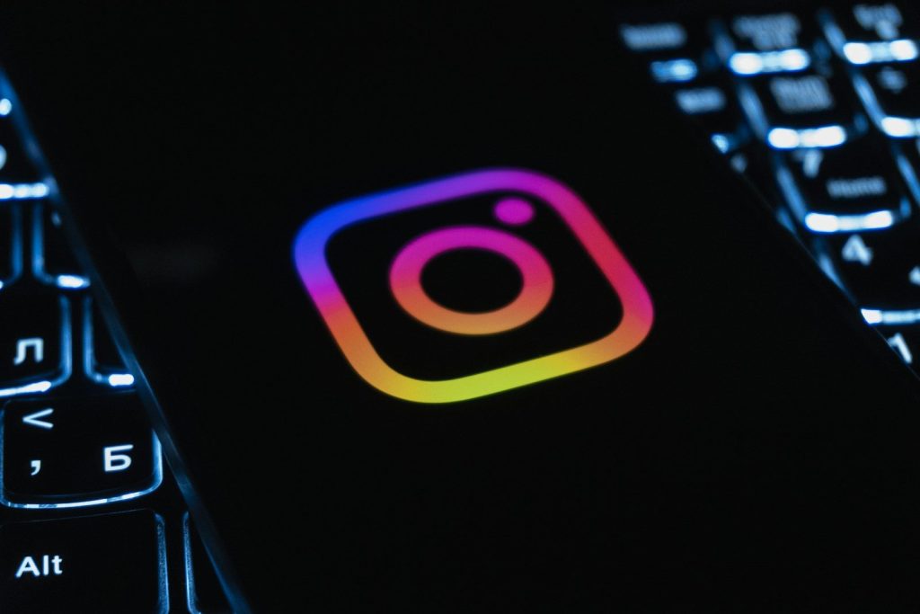 Instagram logo on a dark background with keyboard lights