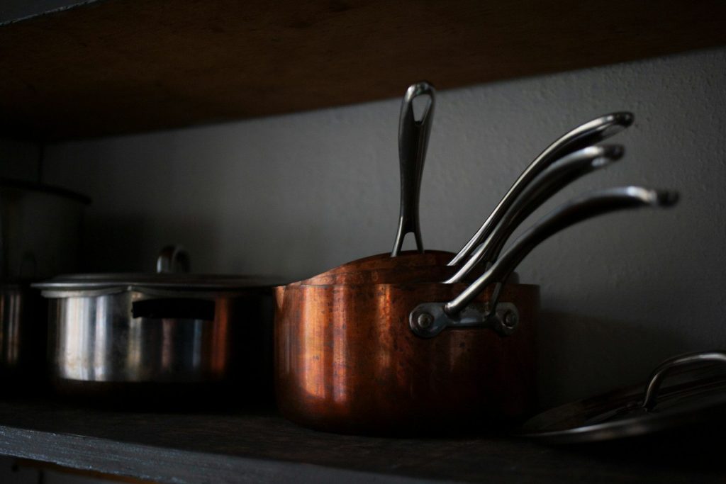 pots and pans are sitting on a shelf