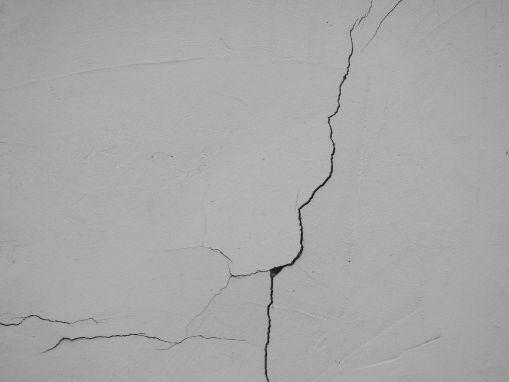 a crack in the side of a white wall