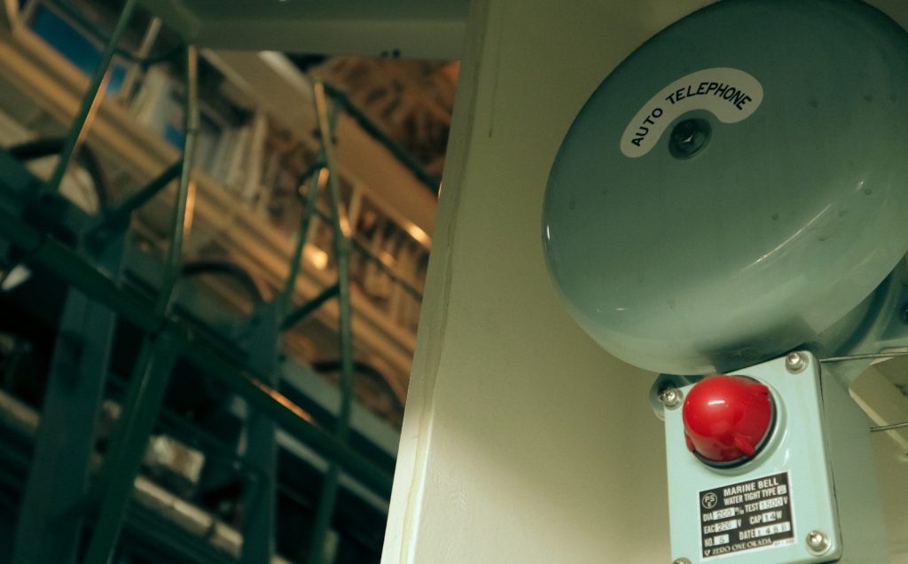 a red light sitting on the side of a building