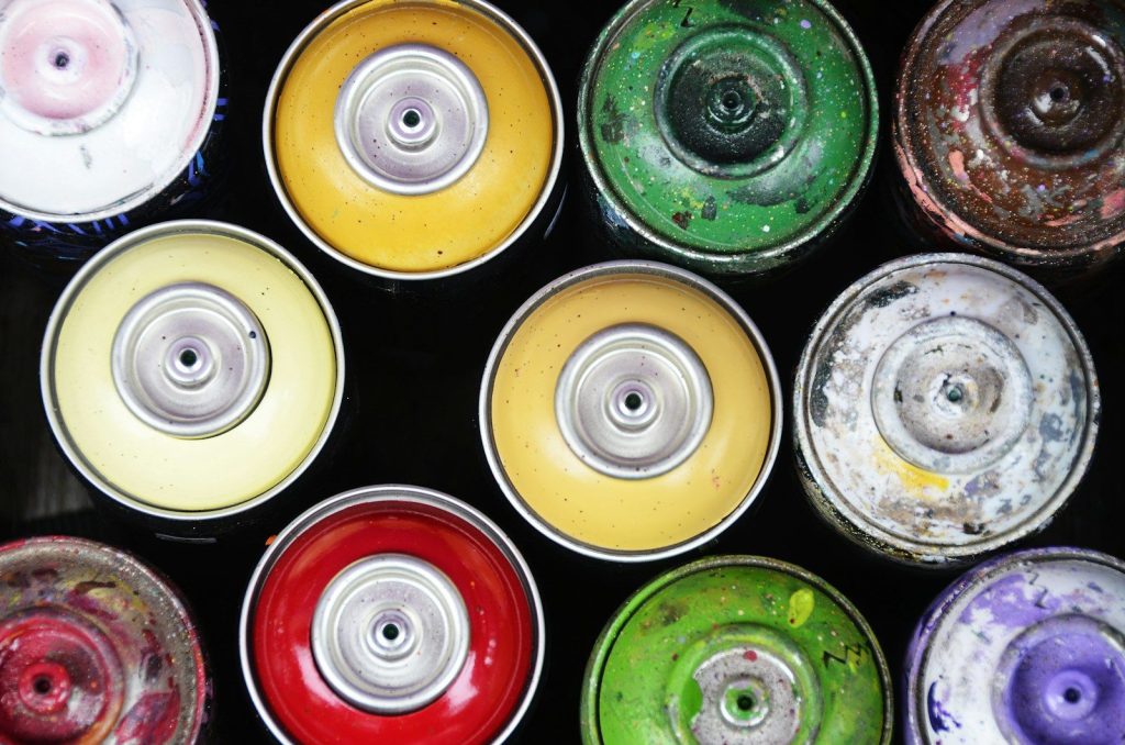 Collection of colorful used spray paint cans