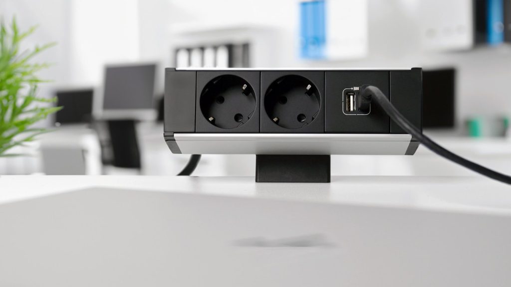A black and white photo of an electrical outlet