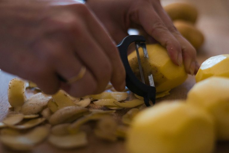 A person cutting up a lemon with a pair of scissors