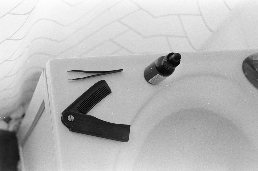 a close up of a sink with a hair dryer and comb