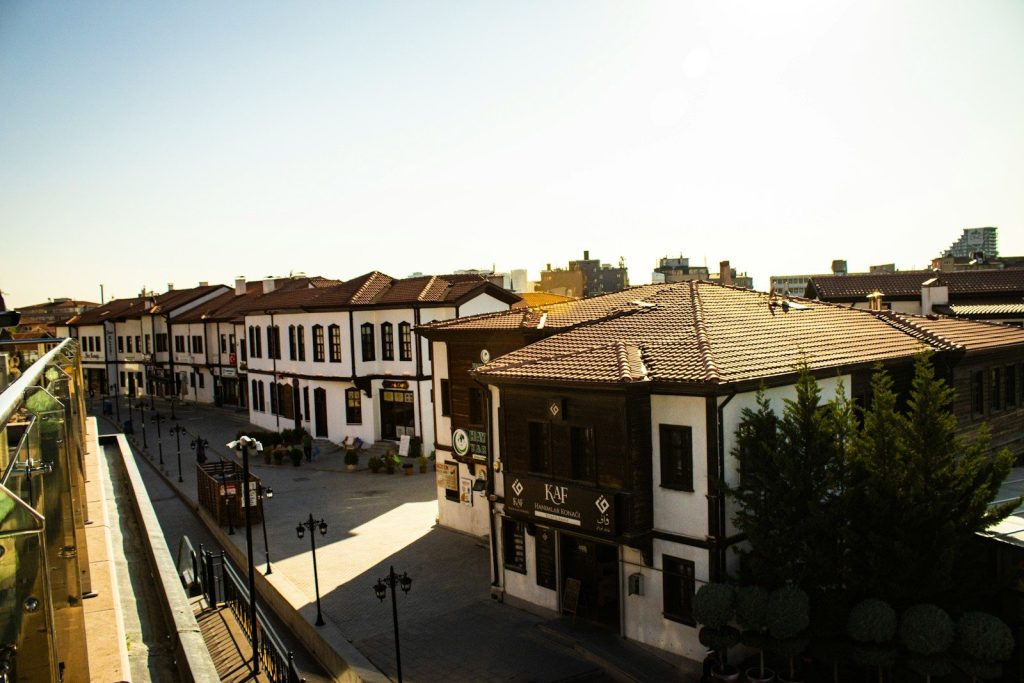 Traditional turkish houses along a sunlit street.