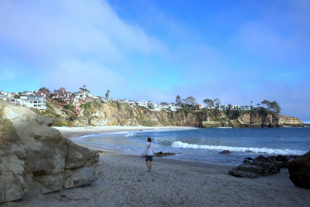 a person standing on a beach next to the ocean