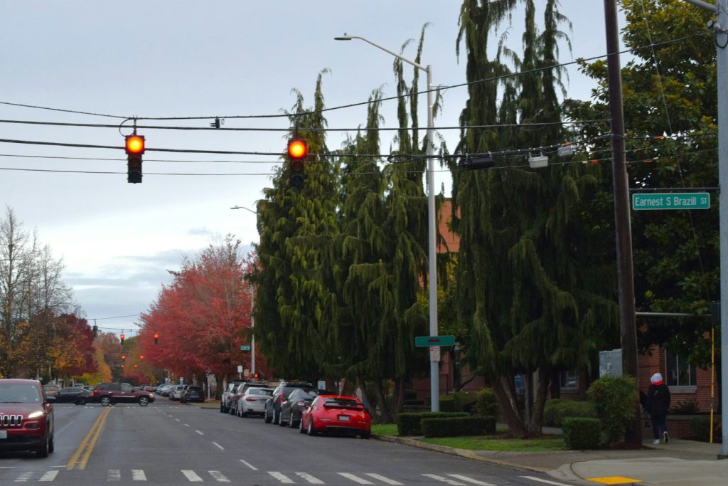 A red traffic light hanging over a city street