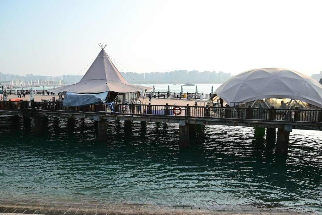 Wooden pier with unique structures over calm water
