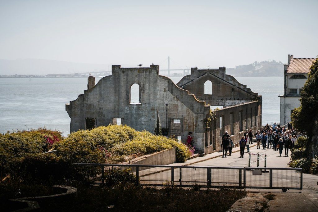 Ruined stone building on an island with visitors